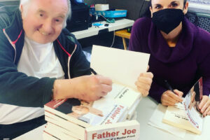 Father Joe and Kathryn Cloward signing Father Joe Life Stories of a Hustler Priest books San Diego, California 2021 800